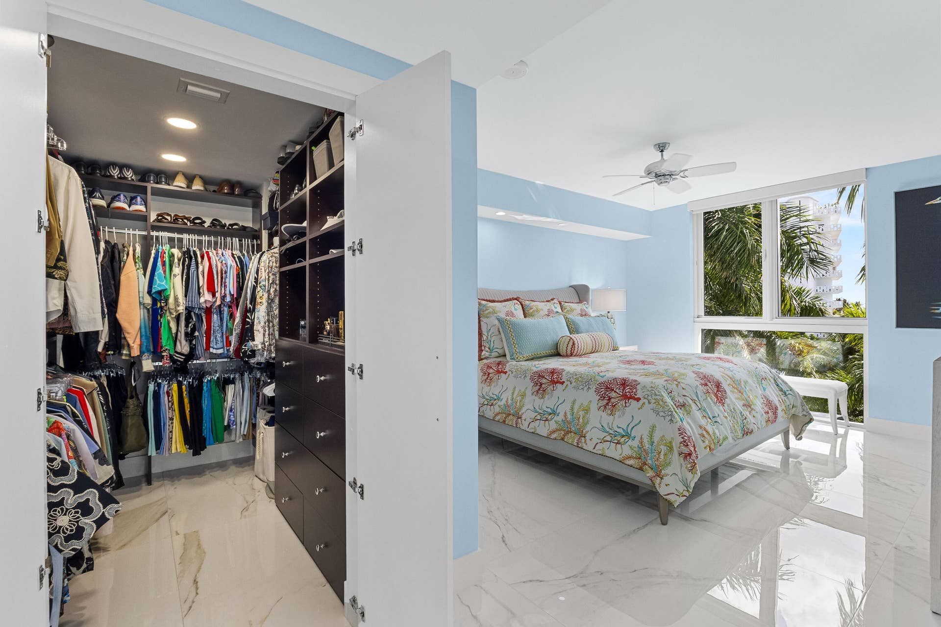 walk in closet with double doors, recessed lighting, and built in organization.