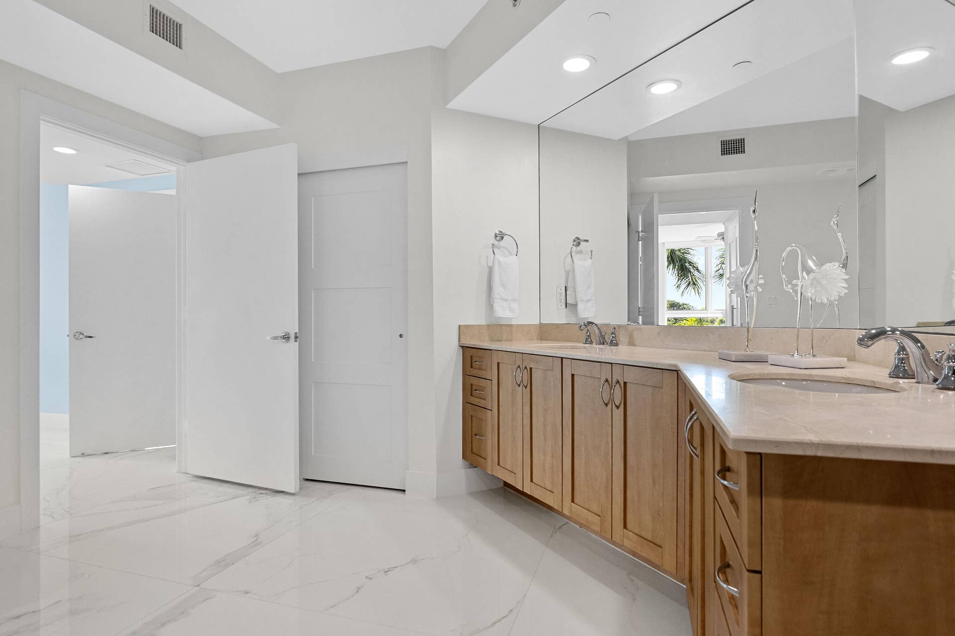 double sinks, and closet inside the bathroom for extra storage.