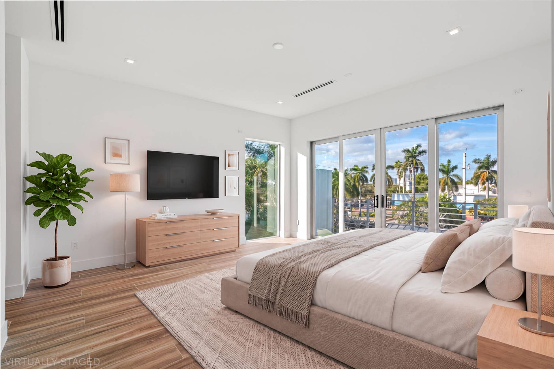 Natural light cascades throughout this exceptional corner unit primary bedroom.