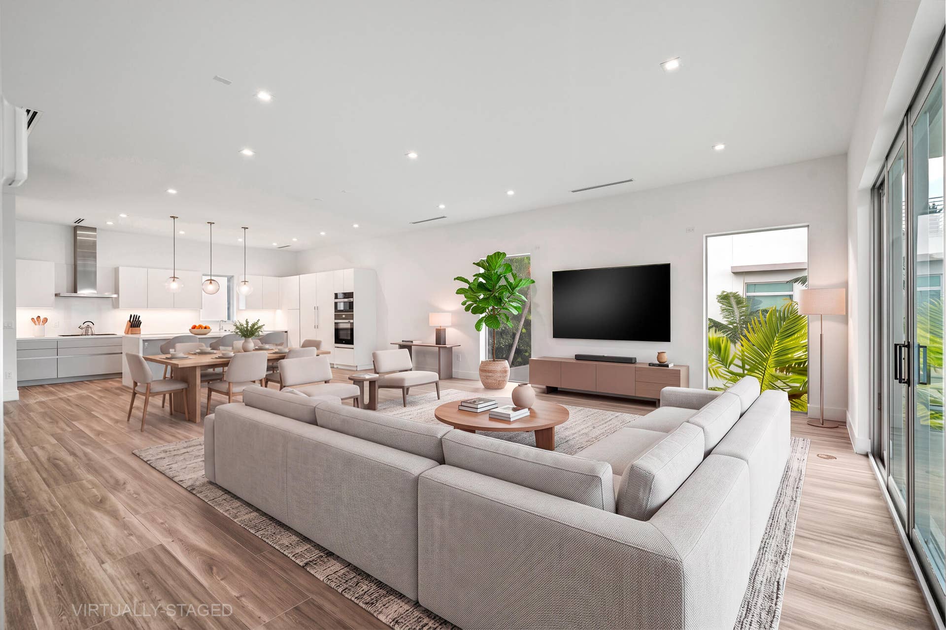 Bright, open, kitchen and living space with Miele and Samsung appliances.