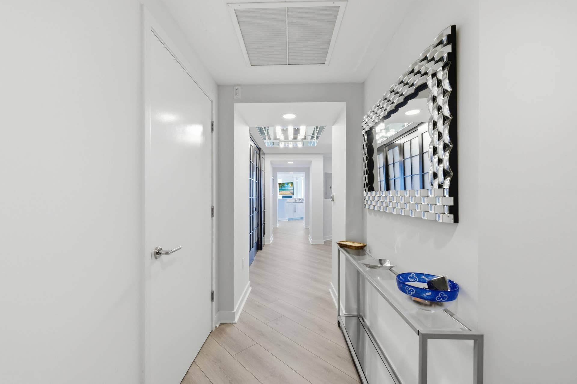 Apartment entrance, den to the left, guest bedroom wing to the right