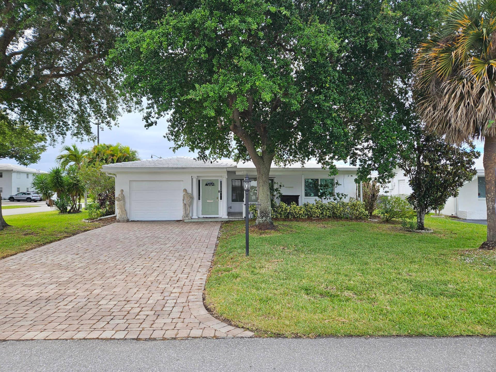 391 Leisure Boulevard, Pompano Beach, FL 33064 Corner lot with large, covered, front porch and double wide, 4 car paver driveway (2023)