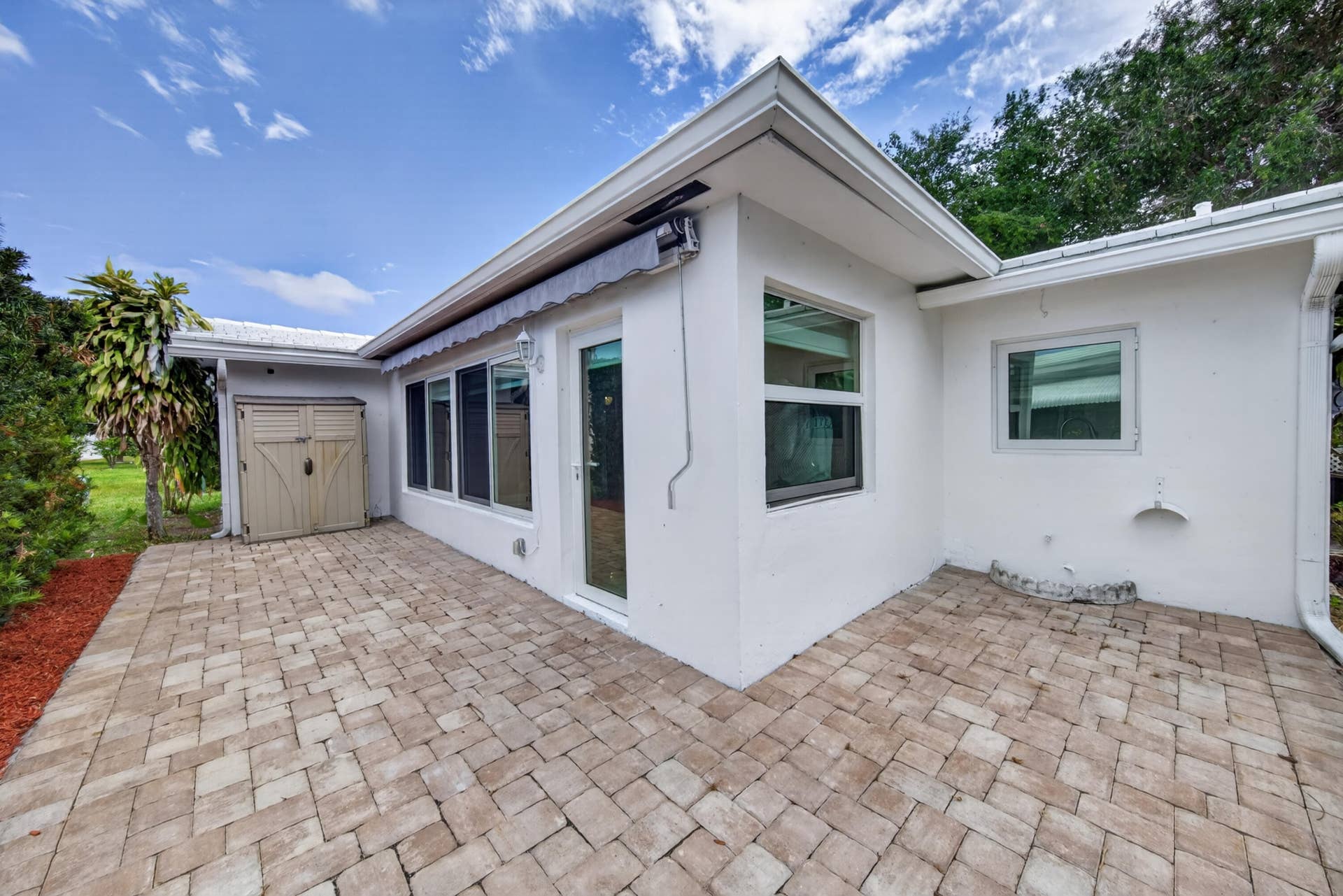 391 Leisure Boulevard, Pompano Beach, FL 33064 Remote control, retractable awning (2023) and backyard pavers porch (2023)