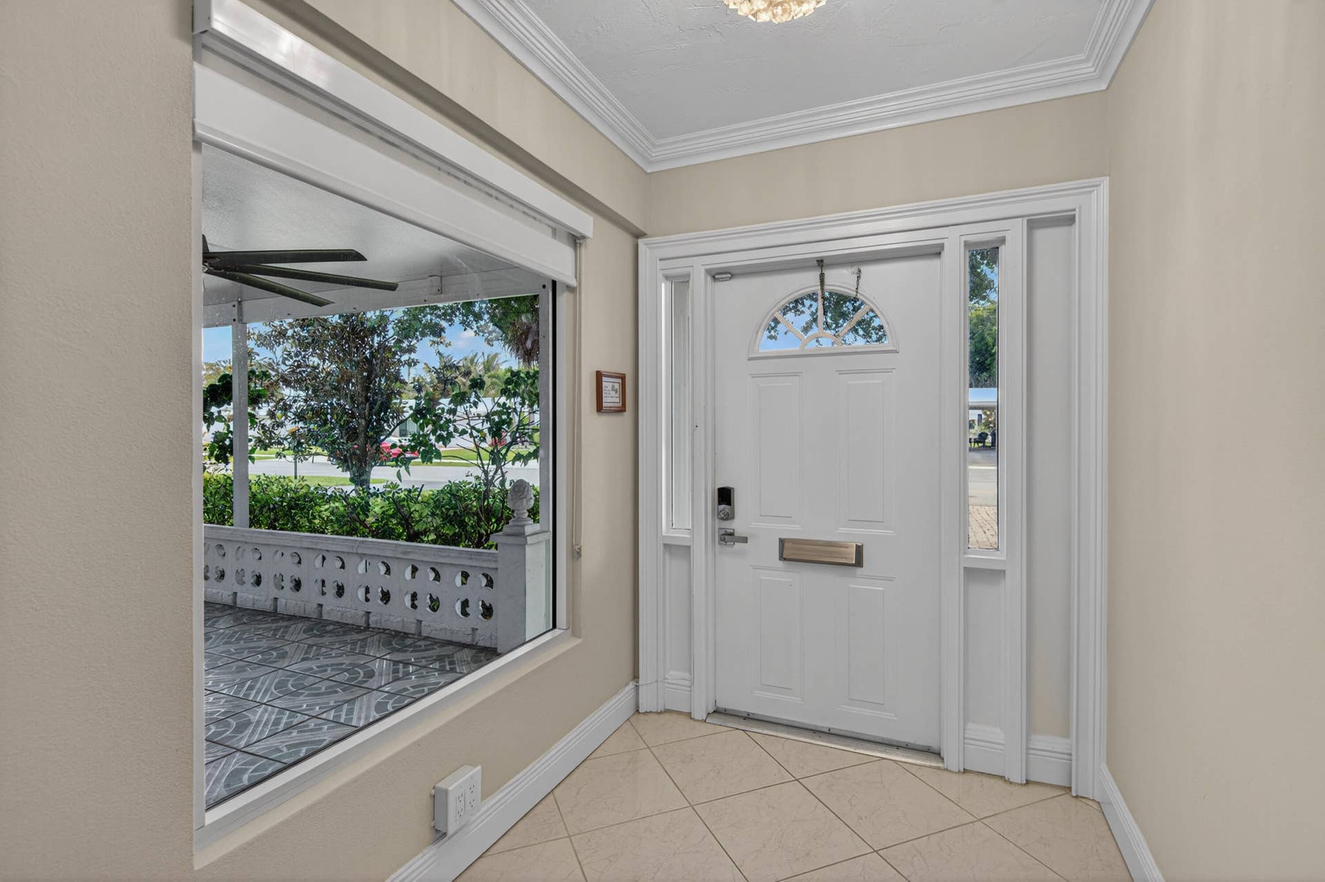 391 Leisure Boulevard, Pompano Beach, FL 33064 Beautiful entrance hallway with window looking out to the front porch