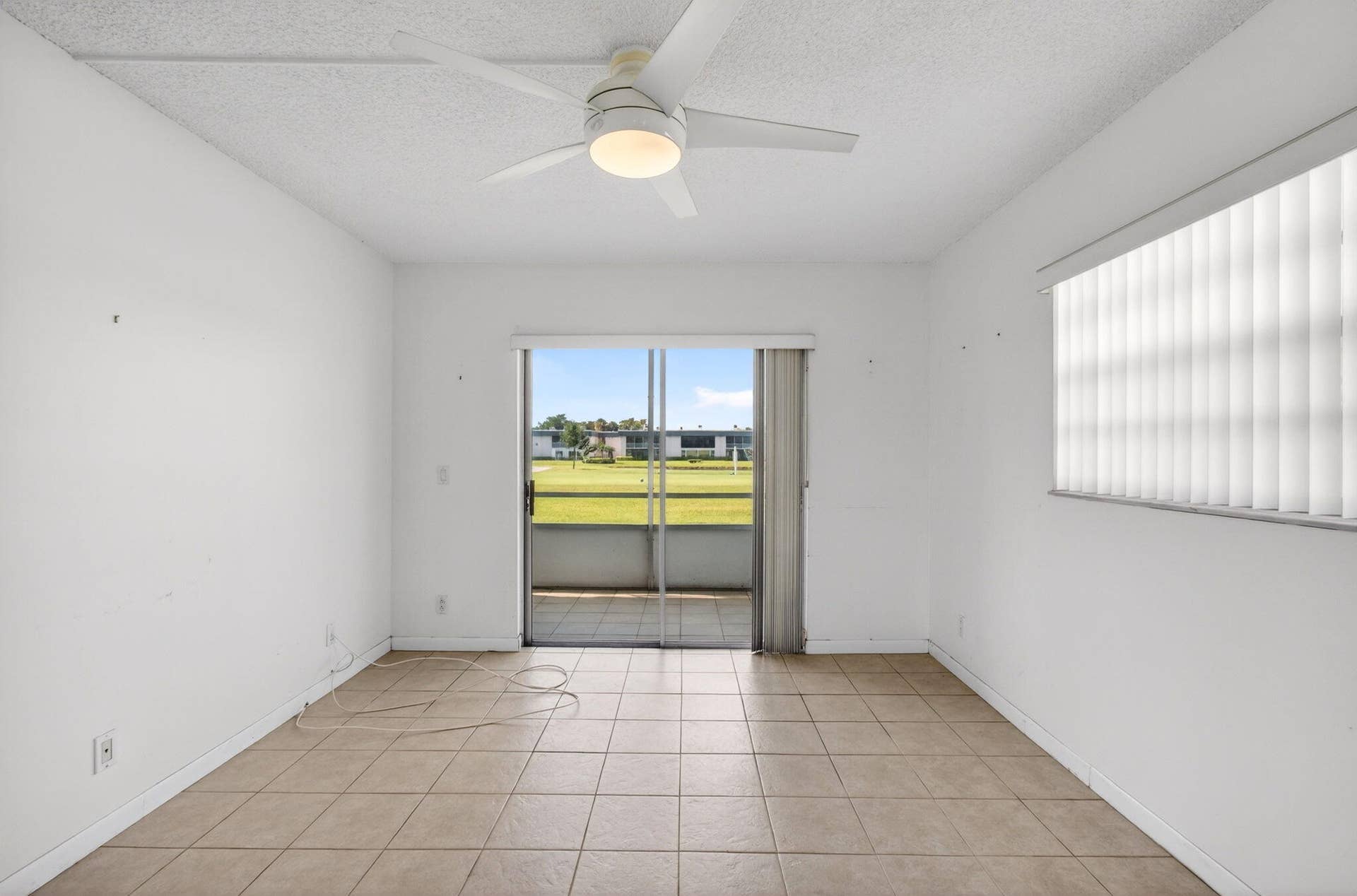 167 Normandy, #D, Delray Beach, FL 33484 Bedroom with Modern Ceiling Fan and Golf Views