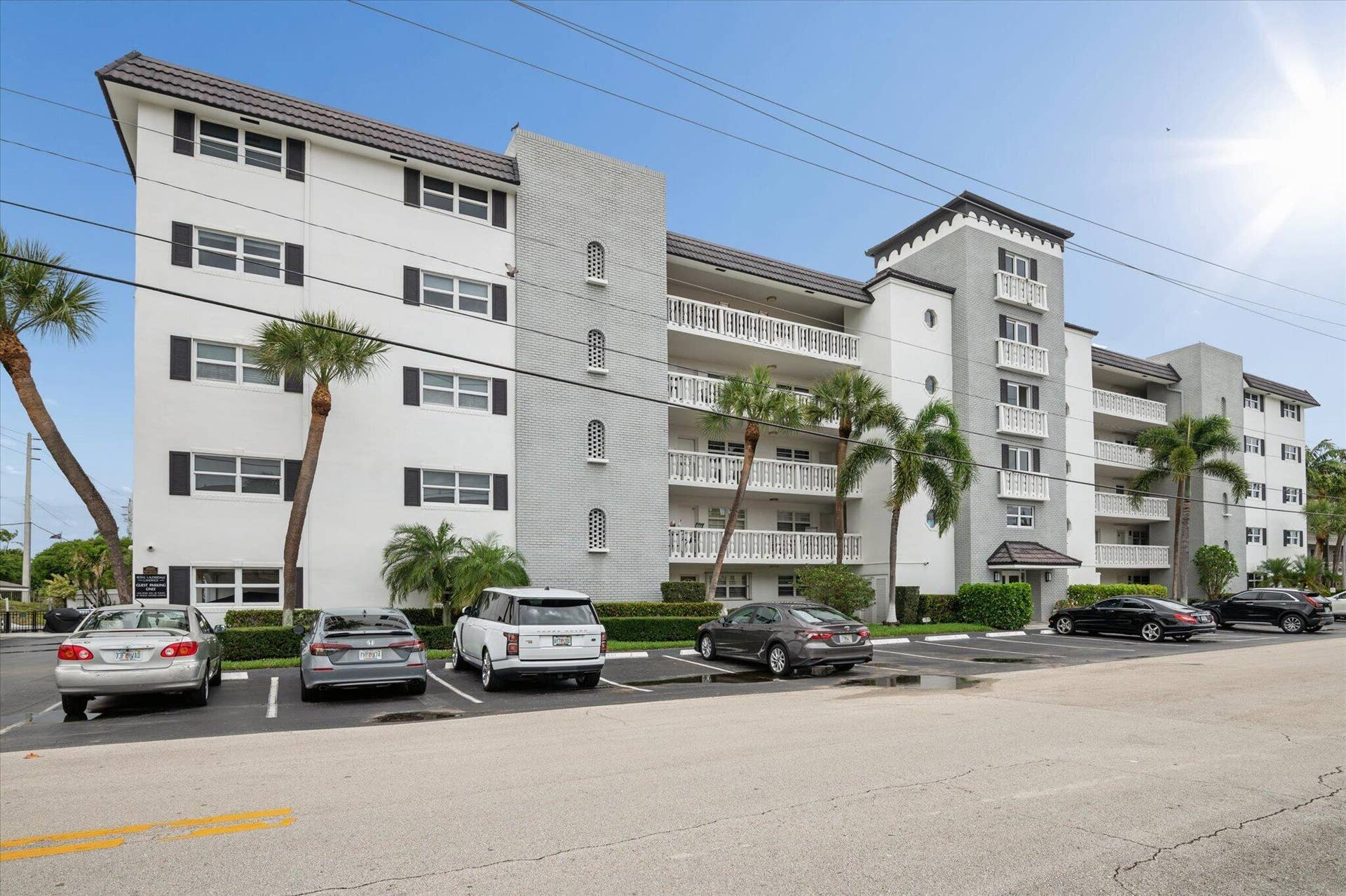 5100 Bayview Drive, #106, Fort Lauderdale, FL 33308 Well-maintained waterfront building with classic coastal architecture and tropical landscaping.