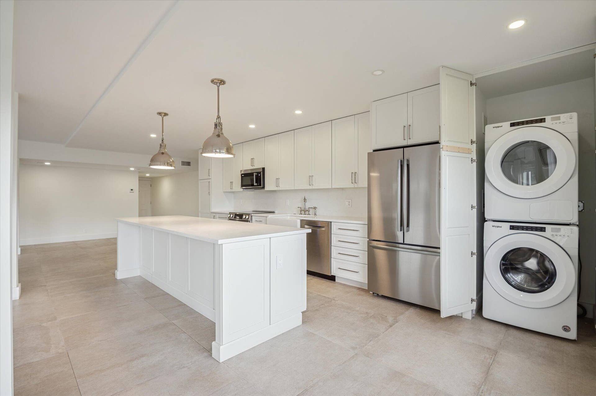5100 Bayview Drive, #106, Fort Lauderdale, FL 33308 Designer kitchen featuring quartz countertops, pendant lighting, and ample storage and full size laundry washer and dryer.