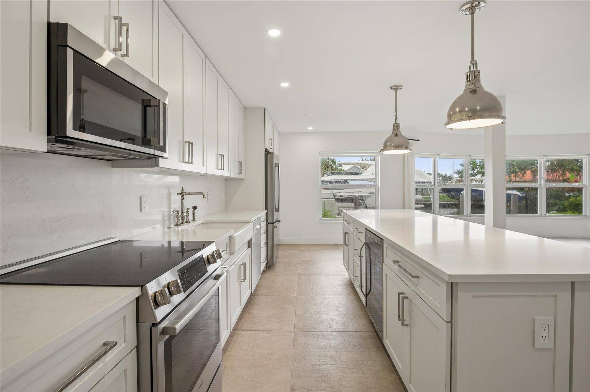 5100 Bayview Drive, #106, Fort Lauderdale, FL 33308 Modern, fully renovated kitchen with custom cabinetry, stainless steel Bosch appliances, and oversized island.