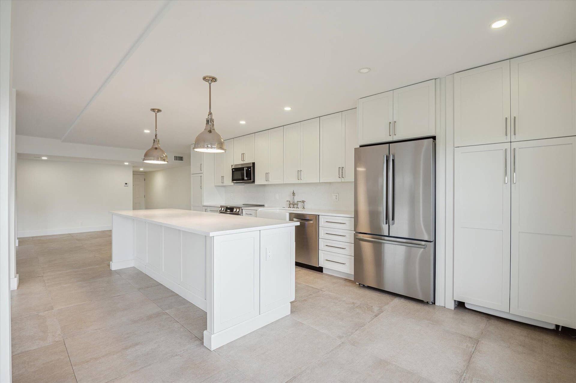 5100 Bayview Drive, #106, Fort Lauderdale, FL 33308 Gourmet-style kitchen with expansive island perfect for casual dining and hosting.