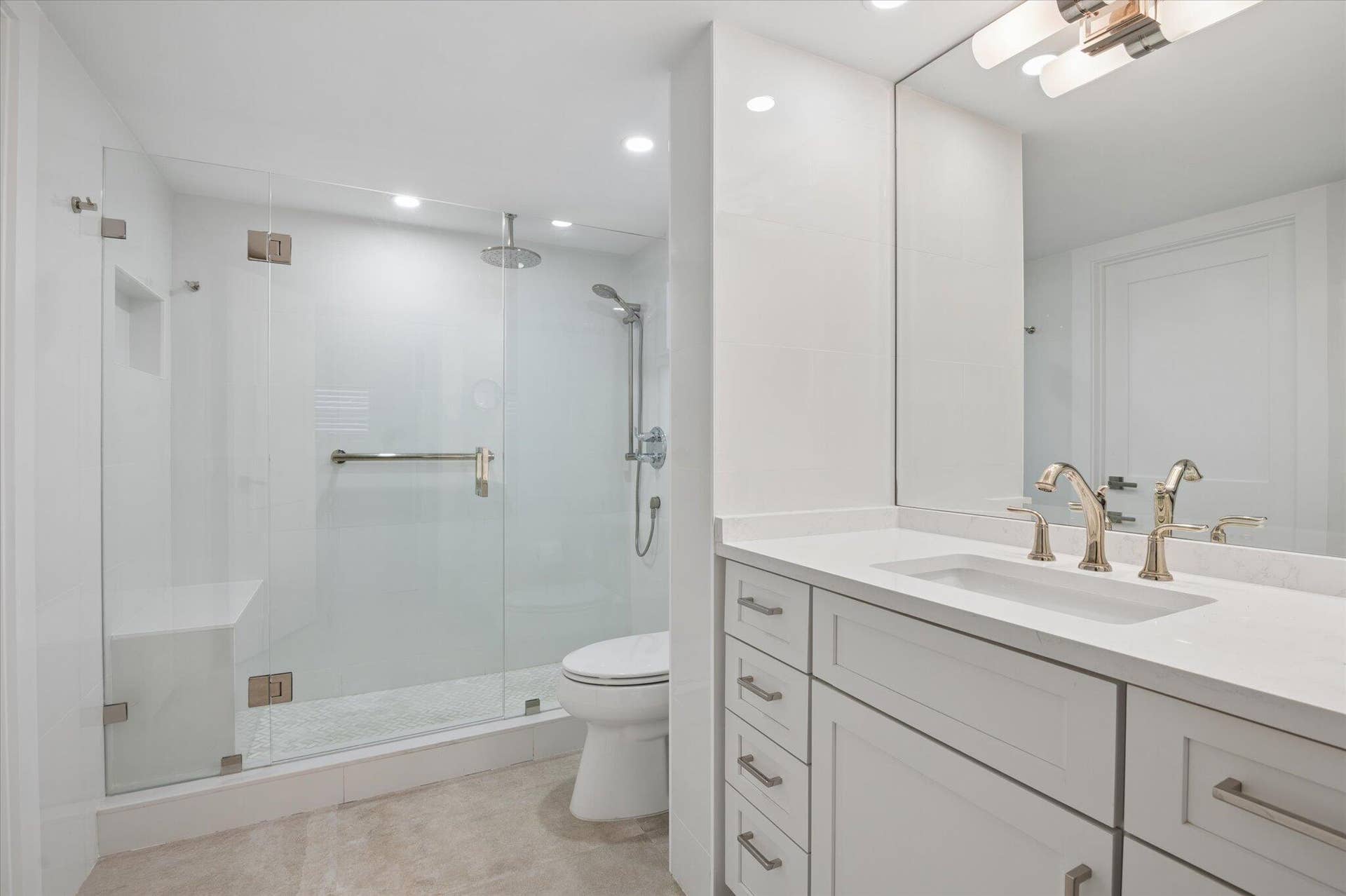 5100 Bayview Drive, #106, Fort Lauderdale, FL 33308 Spa-inspired bathroom with frameless glass walk-in shower, rain head, and sleek modern finishes.