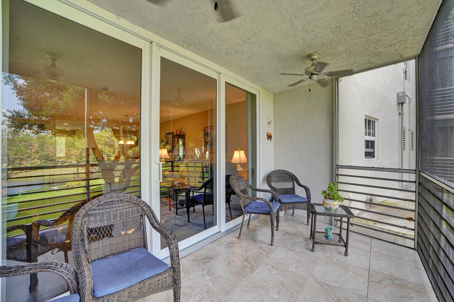 3499 Oaks Way, #Unit 205, Pompano Beach, FL 33069 Impact Sliders to Screened Porch with lake and golf views