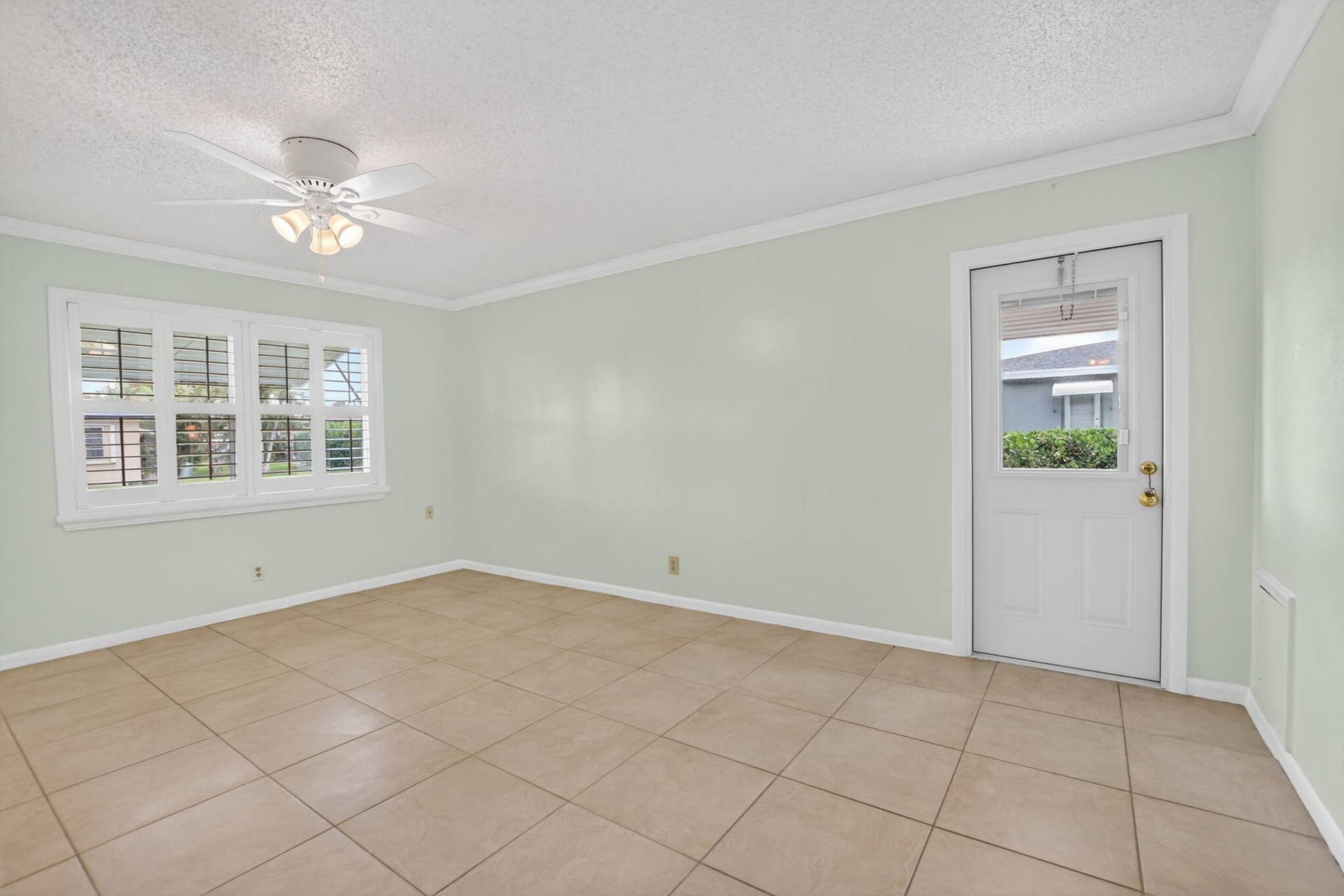 Large Primary bedroom -plantation shutters + tile floors throughout