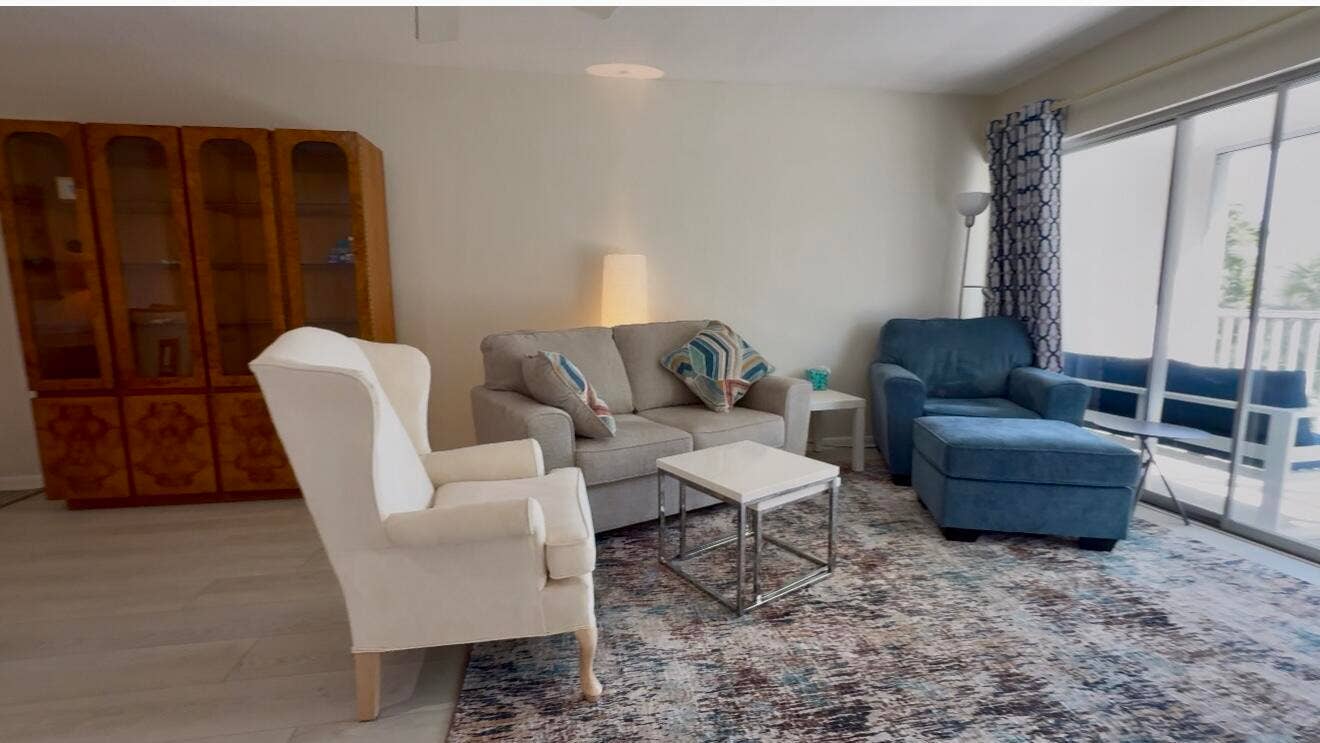 50 Celestial Way, #305, Juno Beach, FL 33408 Living area with deck access