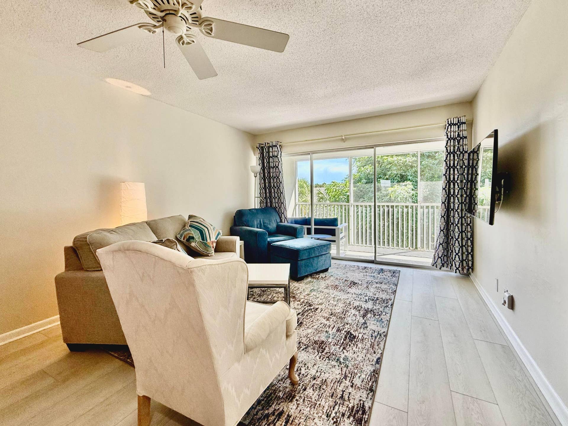 50 Celestial Way, #305, Juno Beach, FL 33408 Living area with deck access