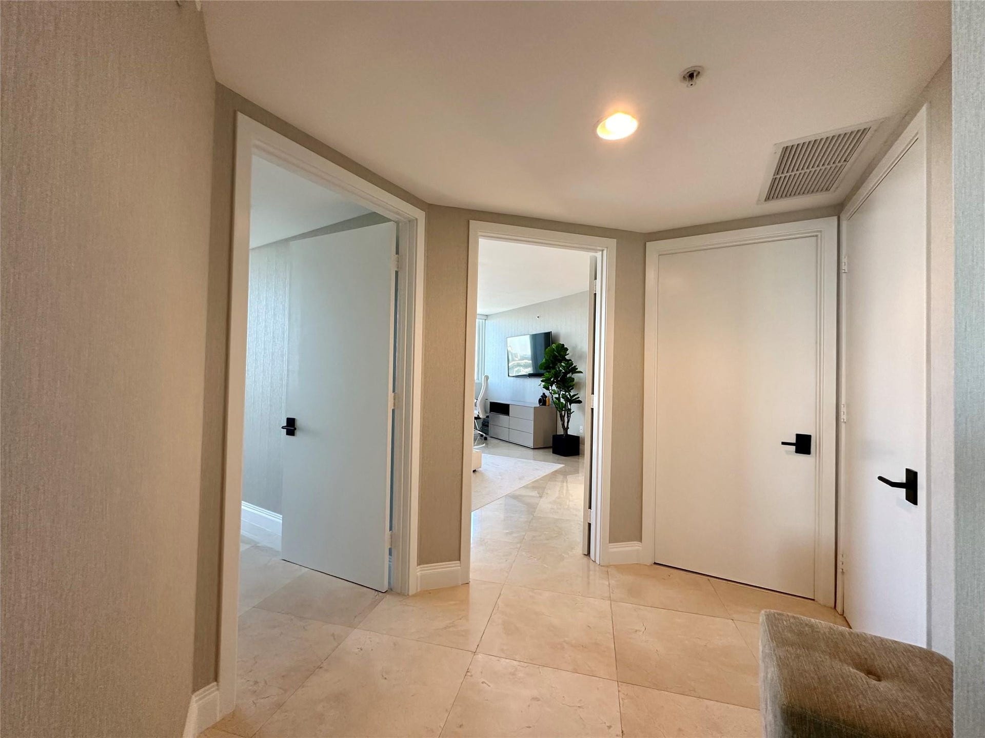 Hallway to master, 2nd bed, half bath and laundry