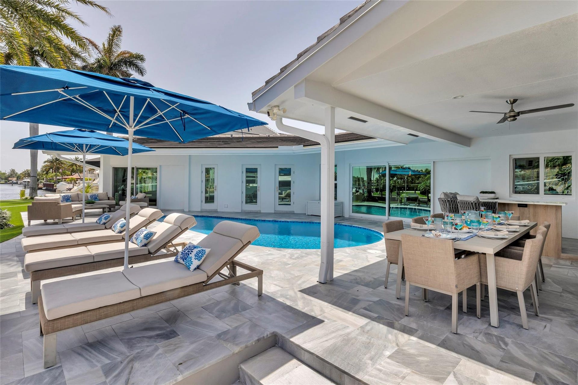 Covered Patio and Outdoor Bar area with outdoor dining fro 8, bar area, TV, Putting Green and amazing canal & intercostal views.