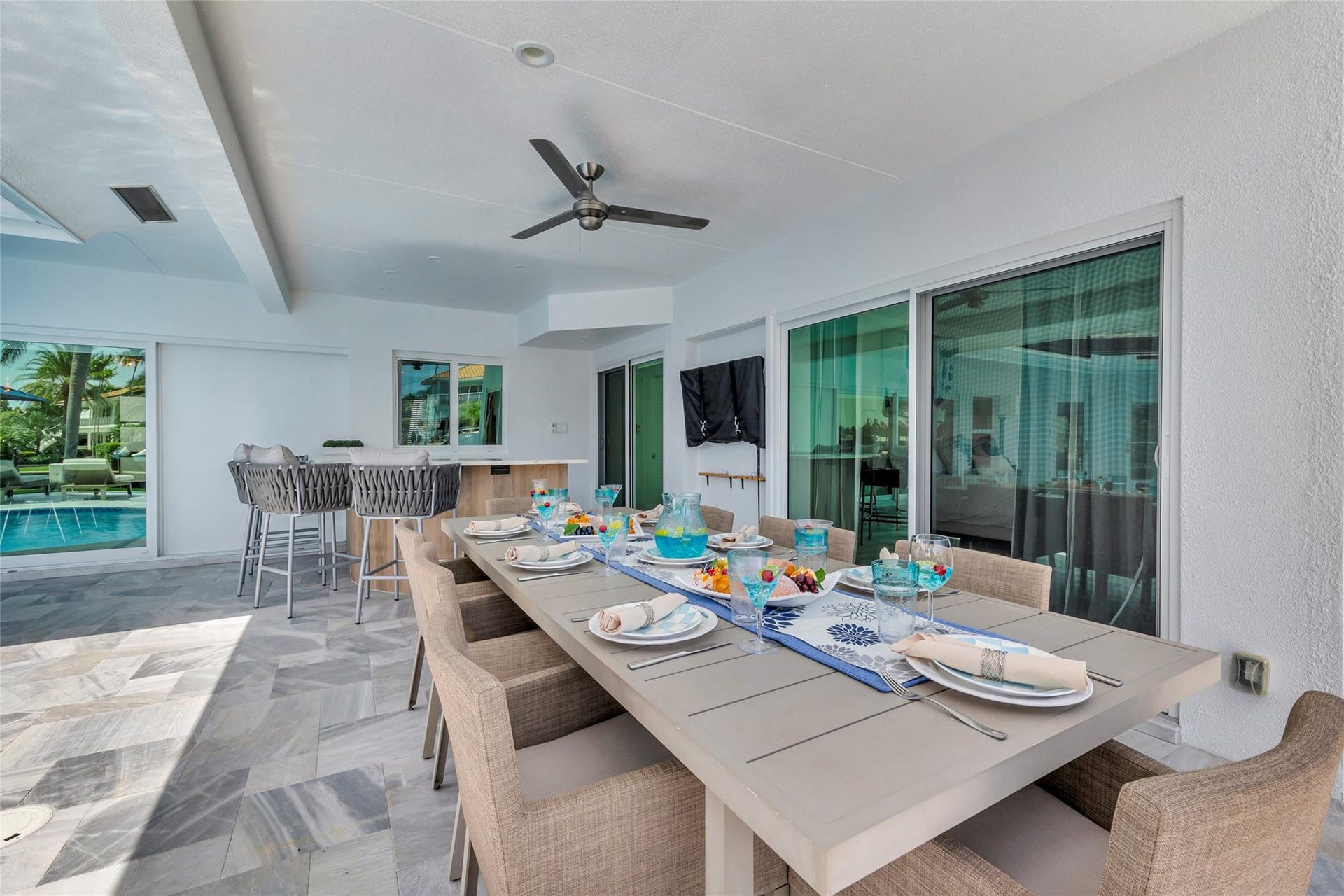 Covered Patio and Outdoor Bar area with outdoor dining fro 8, bar area, TV, Putting Green and amazing canal & intercostal views.