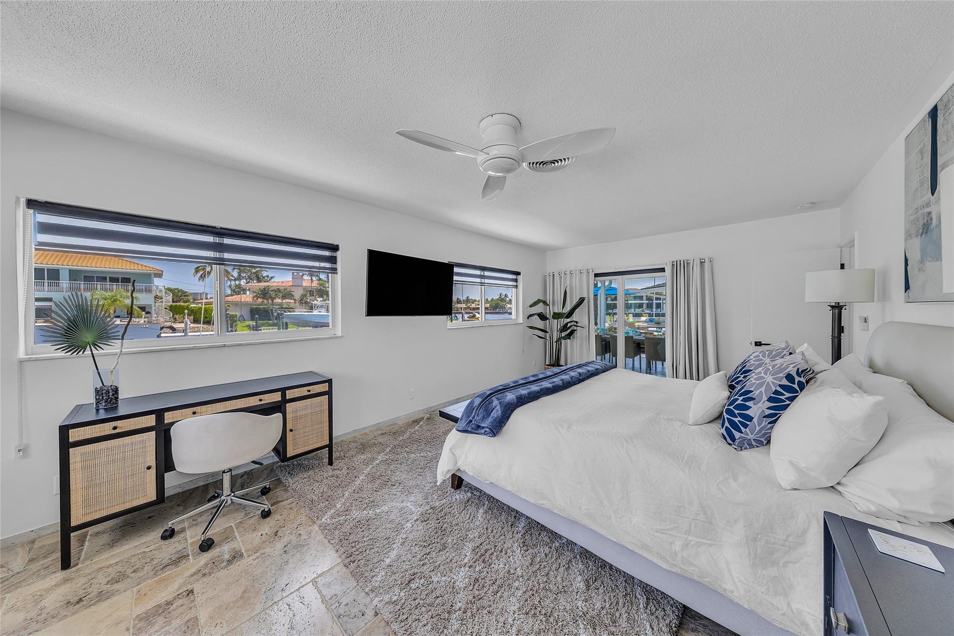 Primary bedroom 1 with sliding glass doors to patio and pool