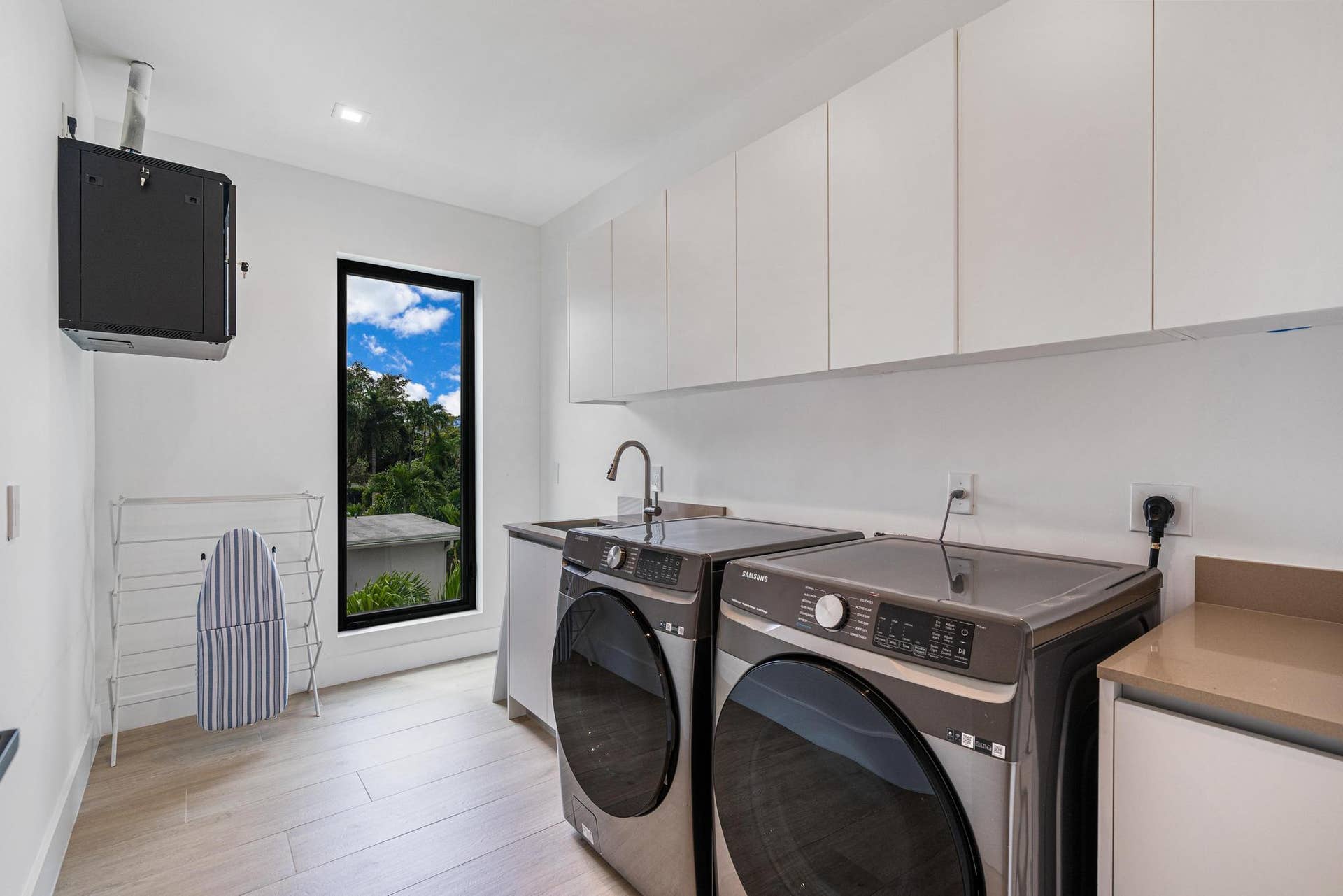 Spacious upstairs laundry room with convenient, well-designed layout.