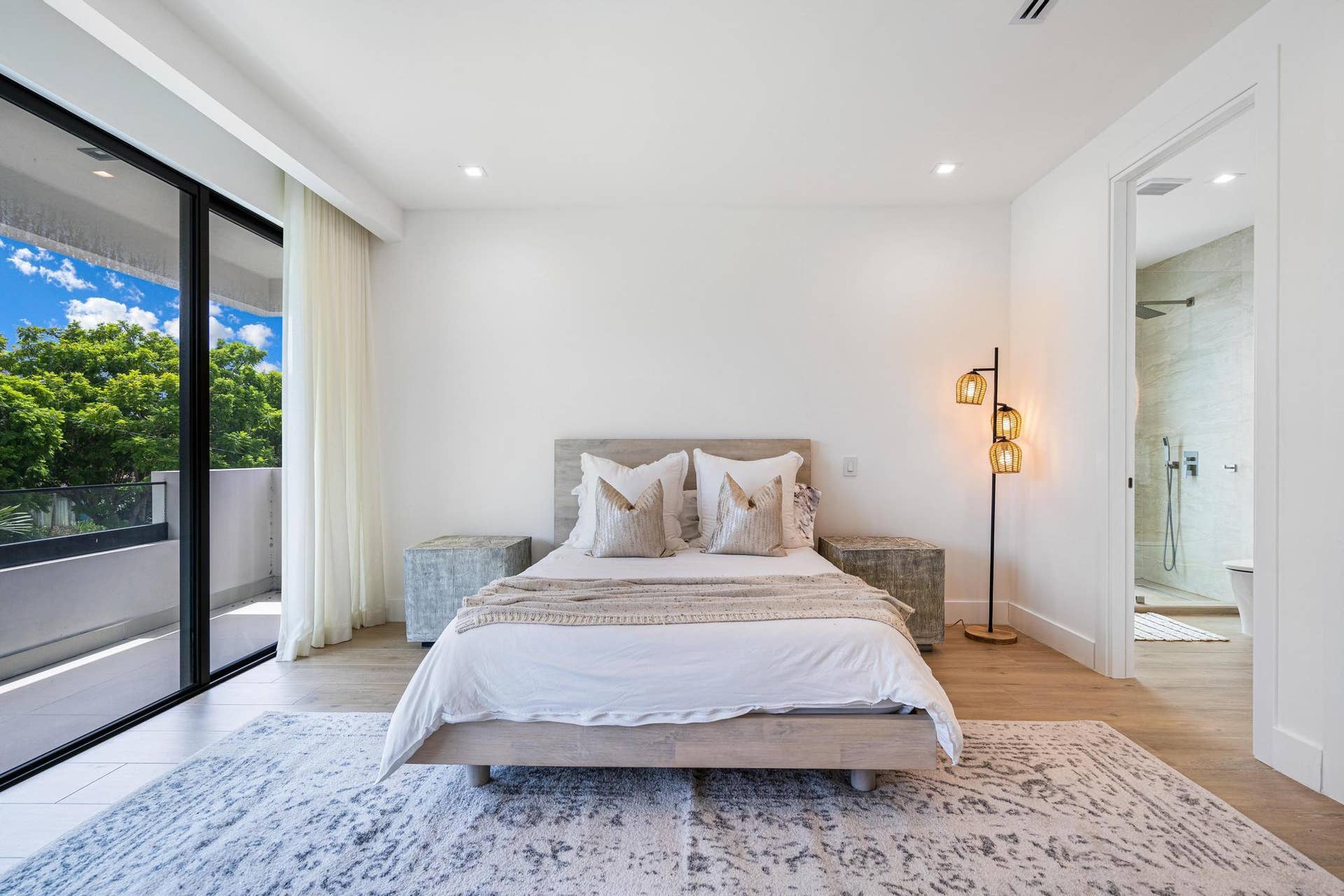 Generous east-facing bedroom filled with natural light and private balcony access.