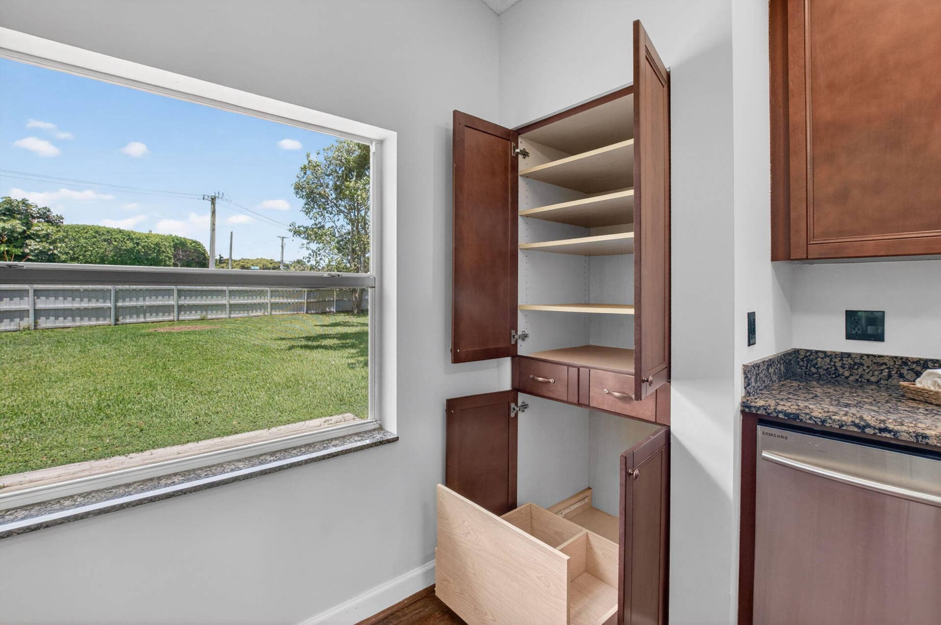 Kitchen showing pantry cabinet features