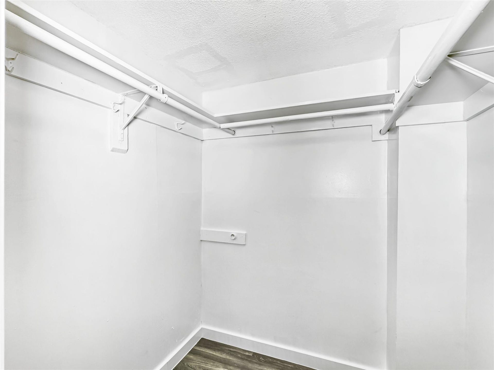2950 N Palm Aire Drive, #506, Pompano Beach, FL 33069 Walk-in closet offers built-in hanging space and additional storage potential. Neutral finishes provide a bright and organized setting.