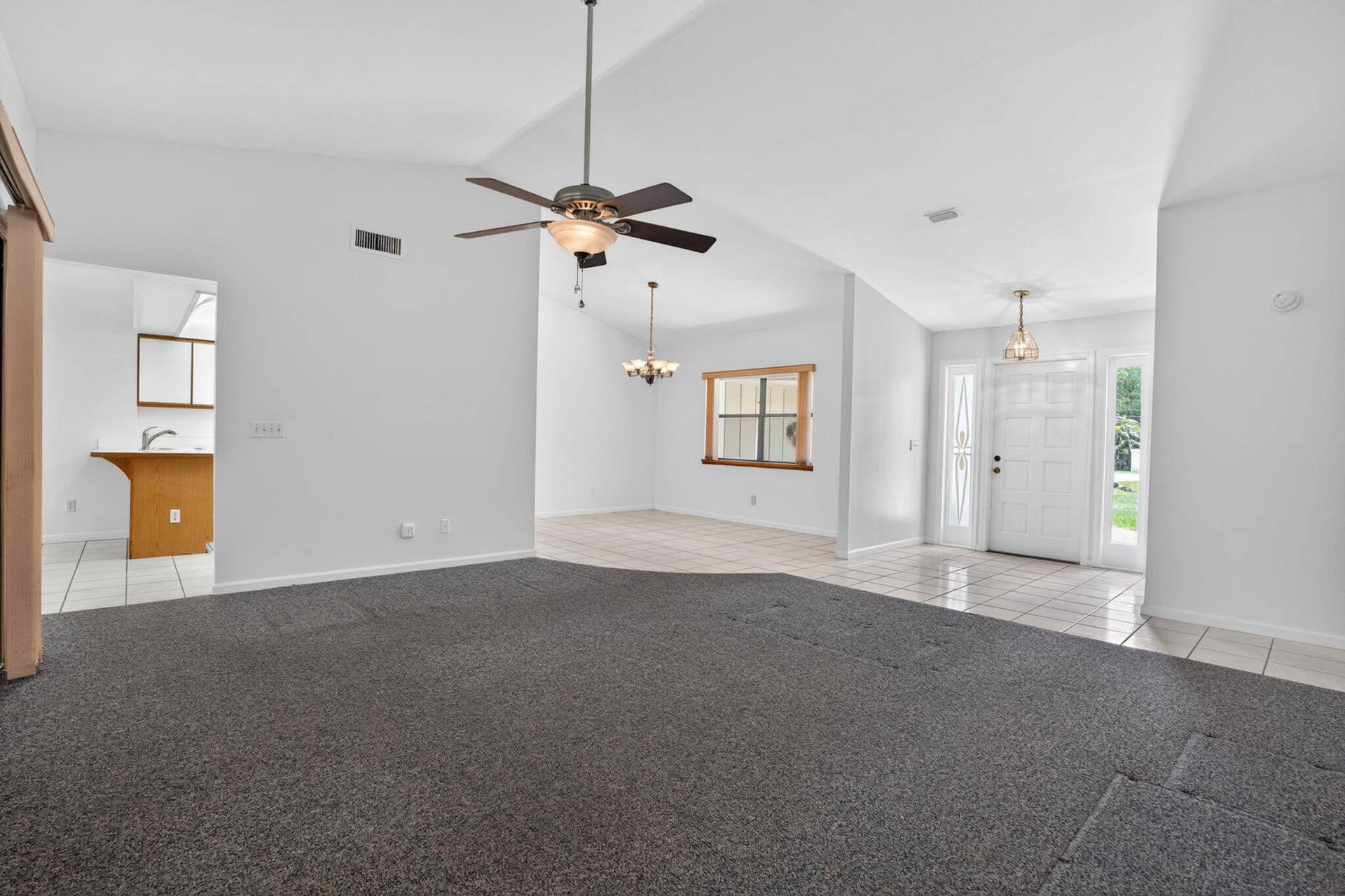 16735 Alexander Run, Jupiter, FL 33478 Living room with view of kitchen and dining room.