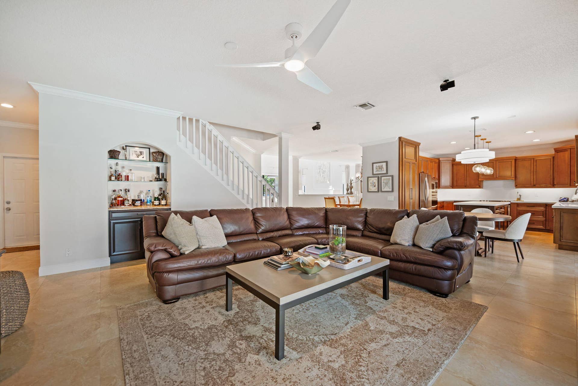 Big family room with beverage bar overlooks the pool patio