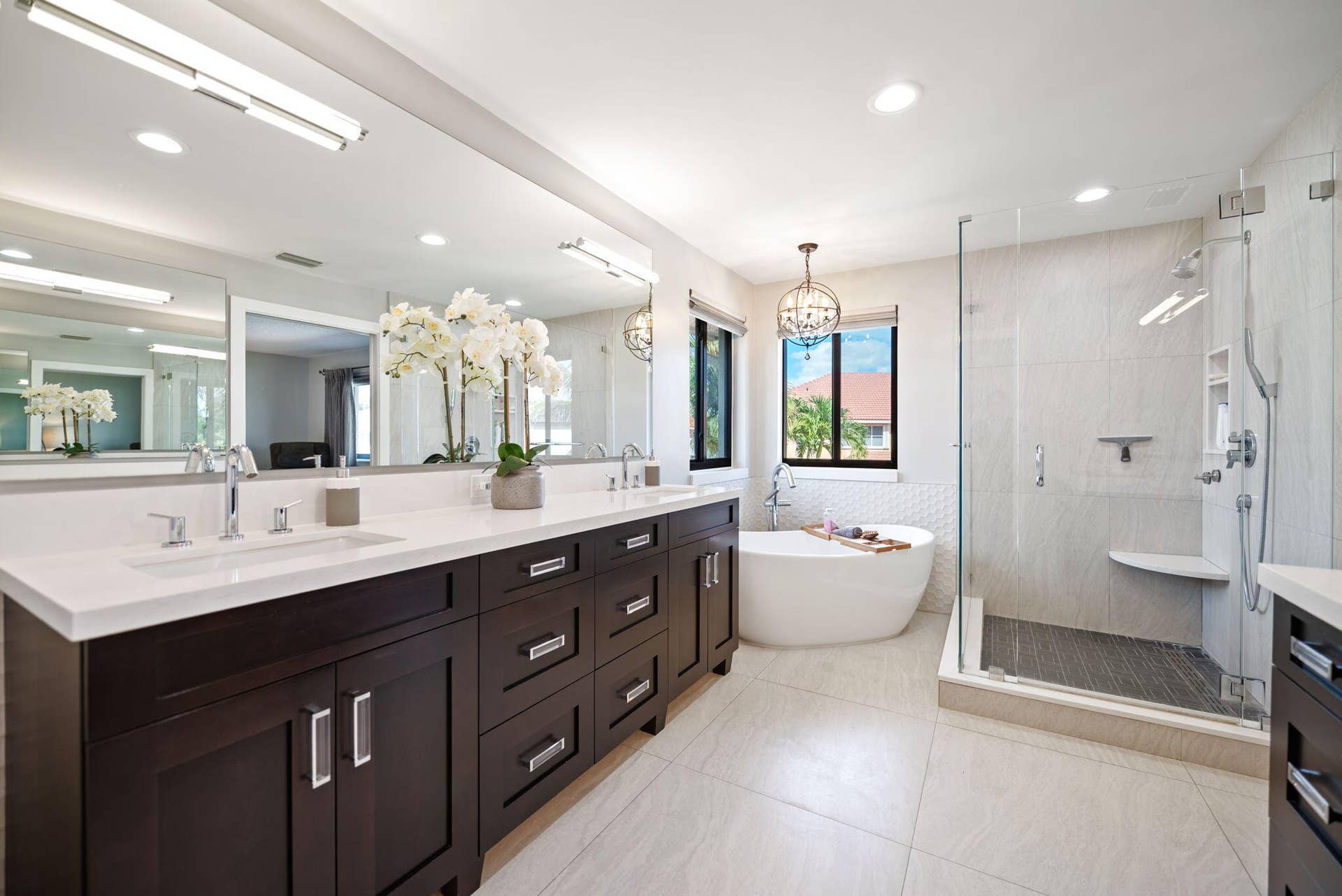 Owner's suite bathroom features a supersized dual sink vanity, freestanding tub and frameless glass shower