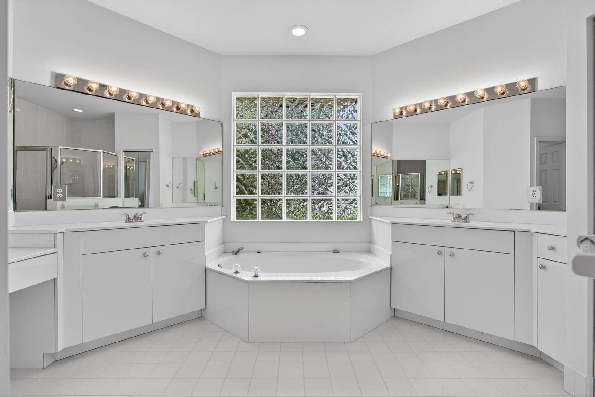Primary bathroom with double vanity and tub