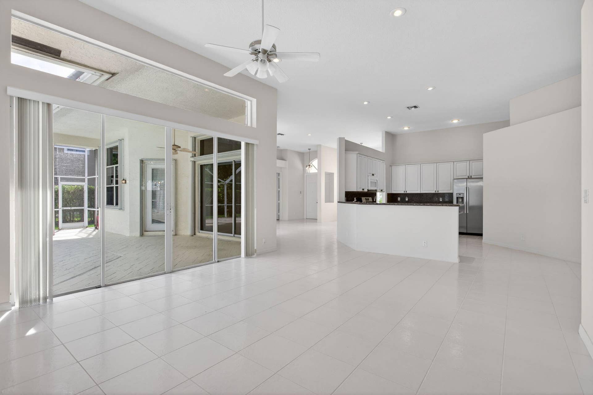 Living area overlooking kitchen and back patio