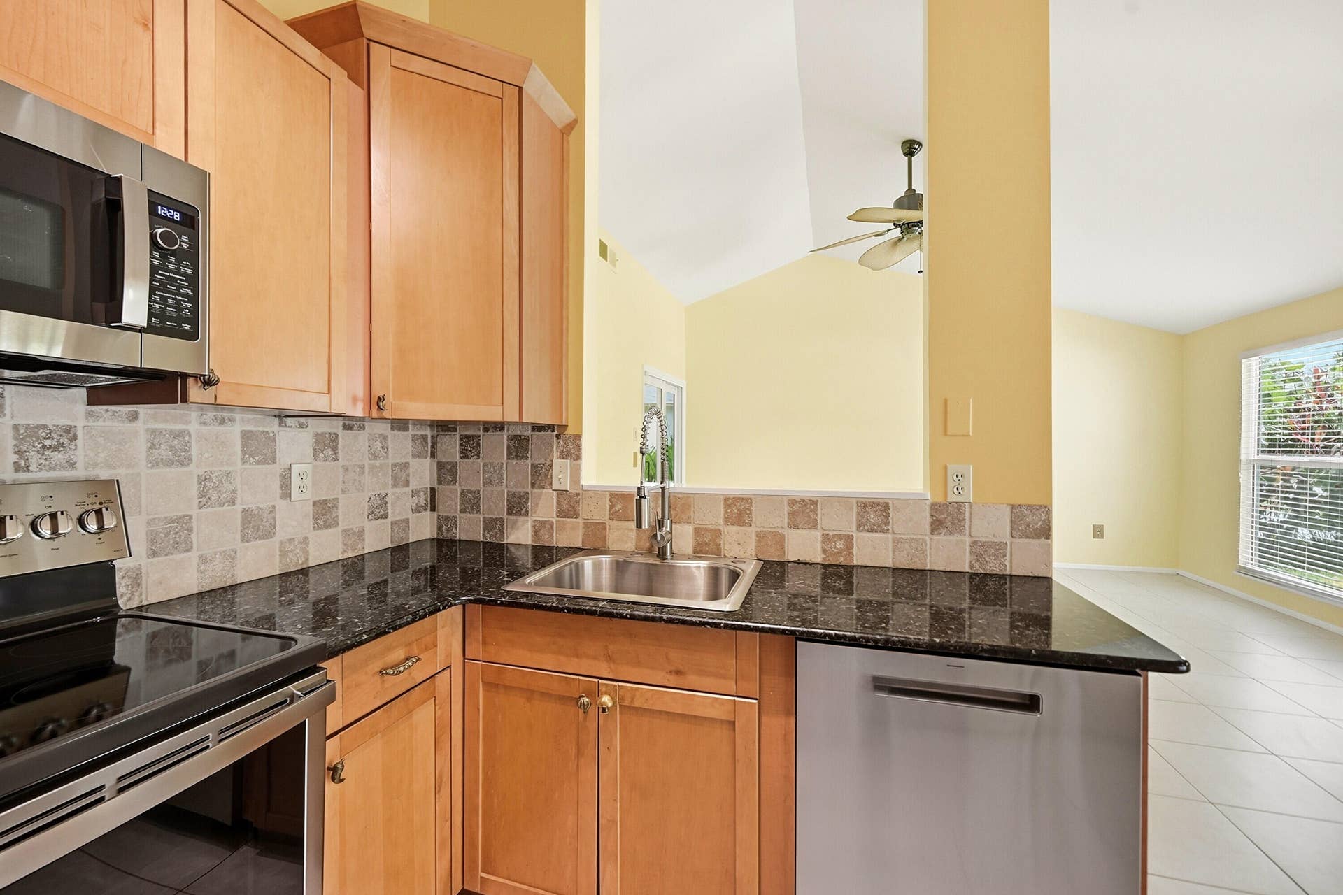 This kitchen boasts newer everything. Cabinets, GE Profile Appliances and Elegant stone counters