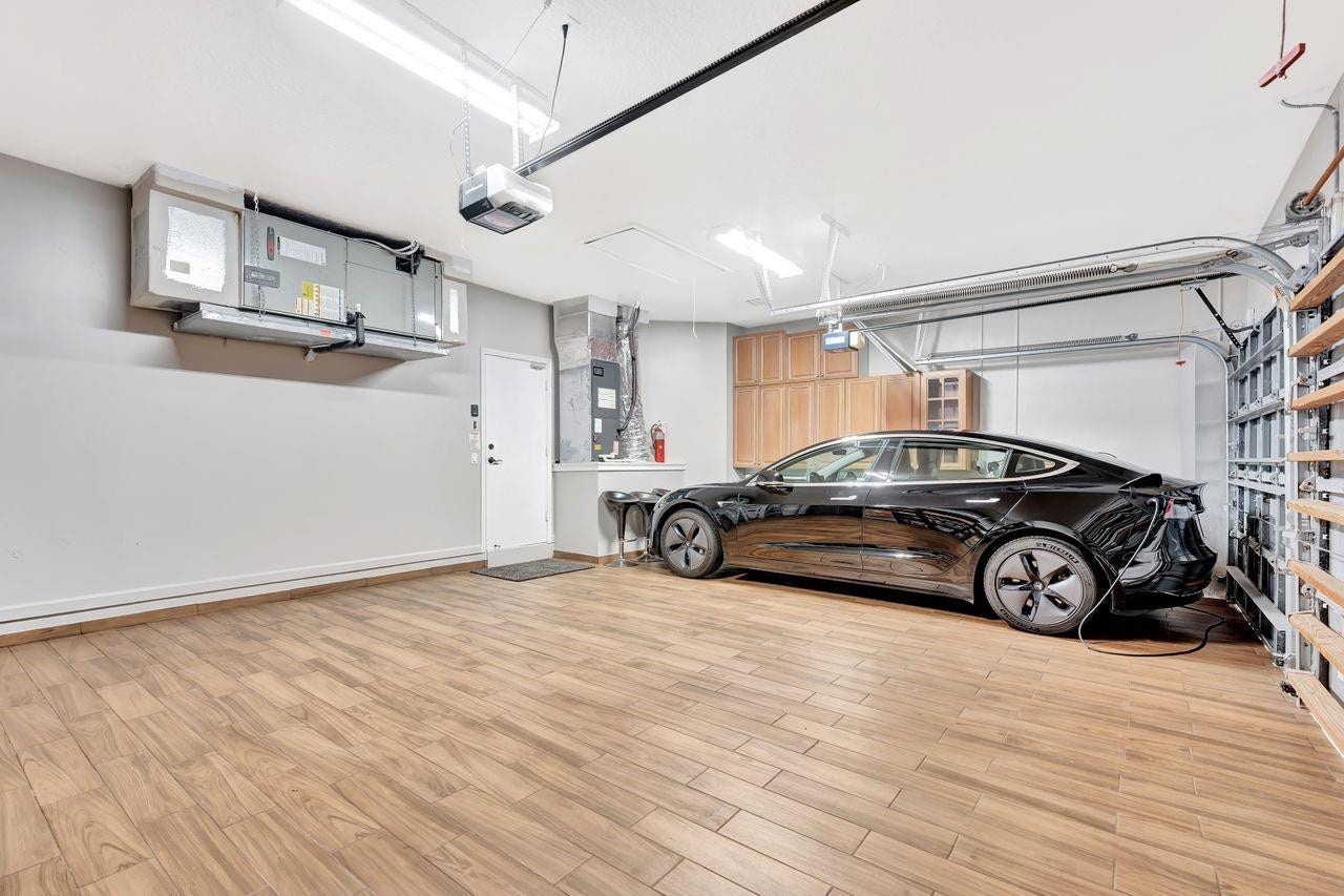 2491 Eagle Run Drive, Weston, FL 33327 The most pristine garage in town! Fully tiled spacious 3CG with EV charger and extra refrigerator.