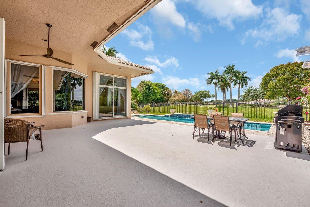 2491 Eagle Run Drive, Weston, FL 33327 Expansive patio over looks heated pool and golf course