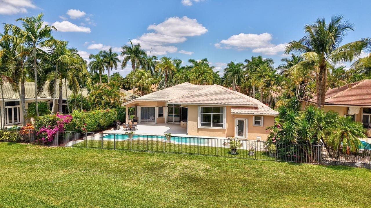 2491 Eagle Run Drive, Weston, FL 33327 Enjoy an expansive terrace, long heated pool and stunning golf views.