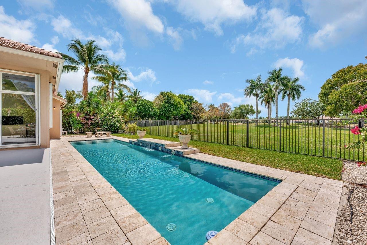 2491 Eagle Run Drive, Weston, FL 33327 Oversized heated pool in fully fenced backyard and views of the golf course in your own backyard. Breathtaking!