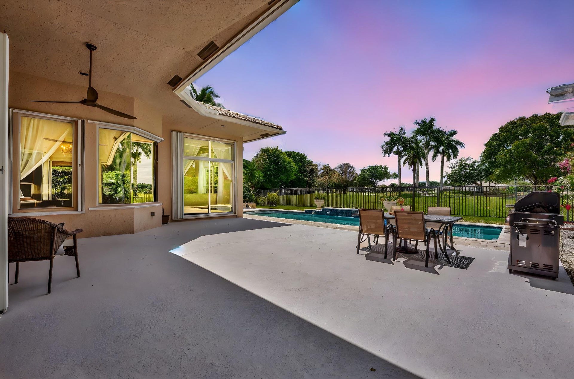 2491 Eagle Run Drive, Weston, FL 33327 Extensive pool deck with new travertine pavers by pool and undercover patio.