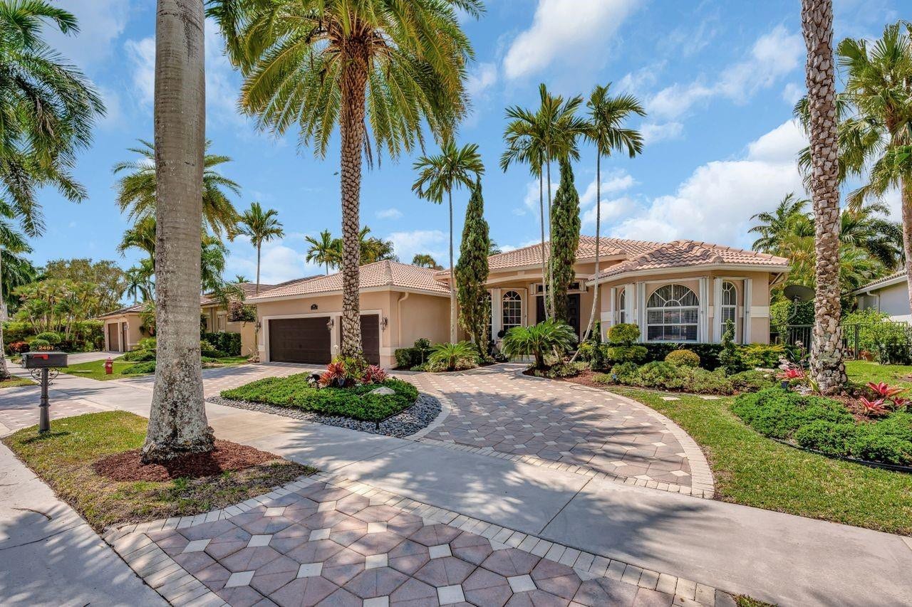 2491 Eagle Run Drive, Weston, FL 33327 Wide brick paver circular driveway, tall palms, manicured landscaping creates beautiful curb appeal.