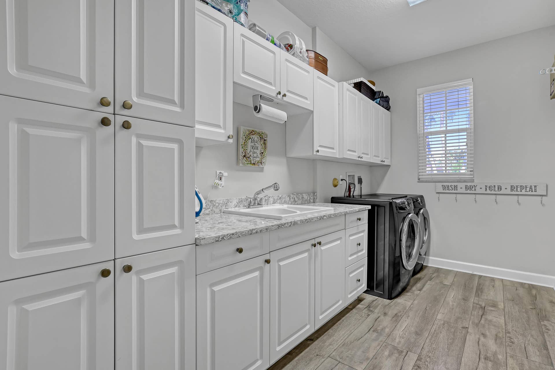1436 Stonehaven Estates Drive, West Palm Beach, FL 33411 Laundry room with sink and storage