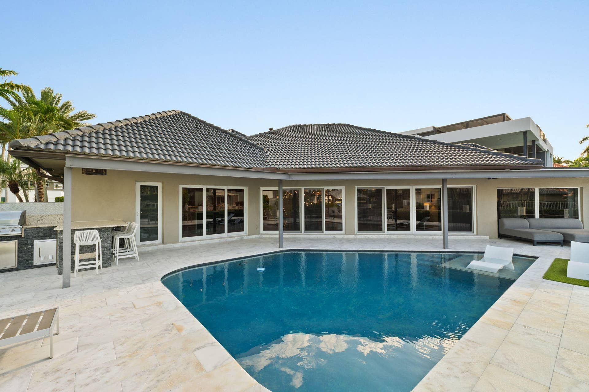 3321 NE 59th Street, Fort Lauderdale, FL 33308 pool and sofa area