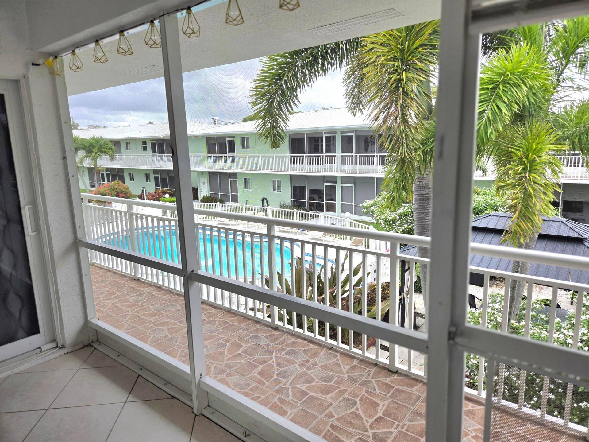 2100 NE 38th Street NE, #207, Lighthouse Point, FL 33064 View of the pool from the lanai