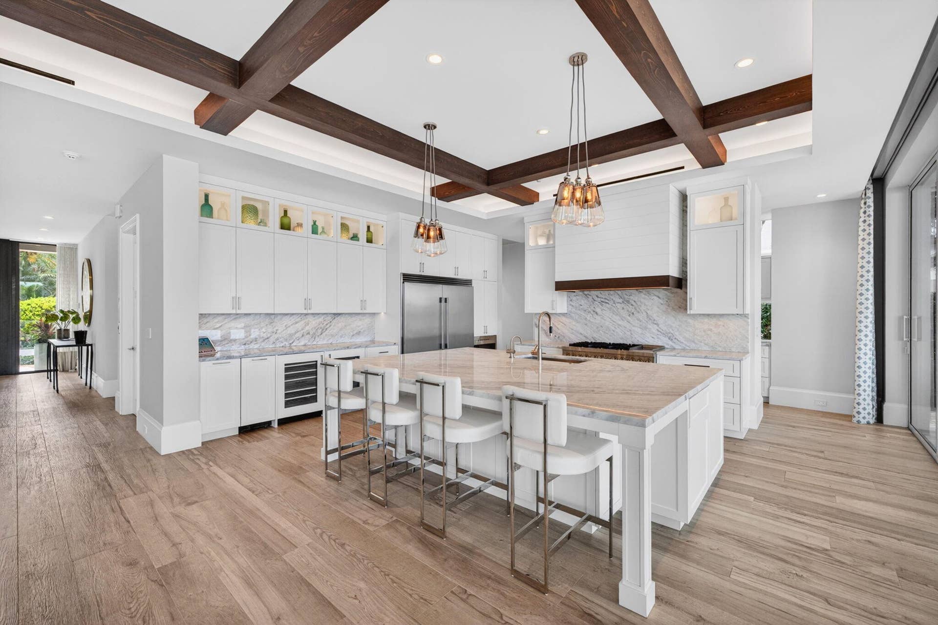 Open concept living at its finest! Incredible chefs kitchen (plus separate caterers kitchen area). an entire wall of glass sliders open inside to the outdoor terrace.