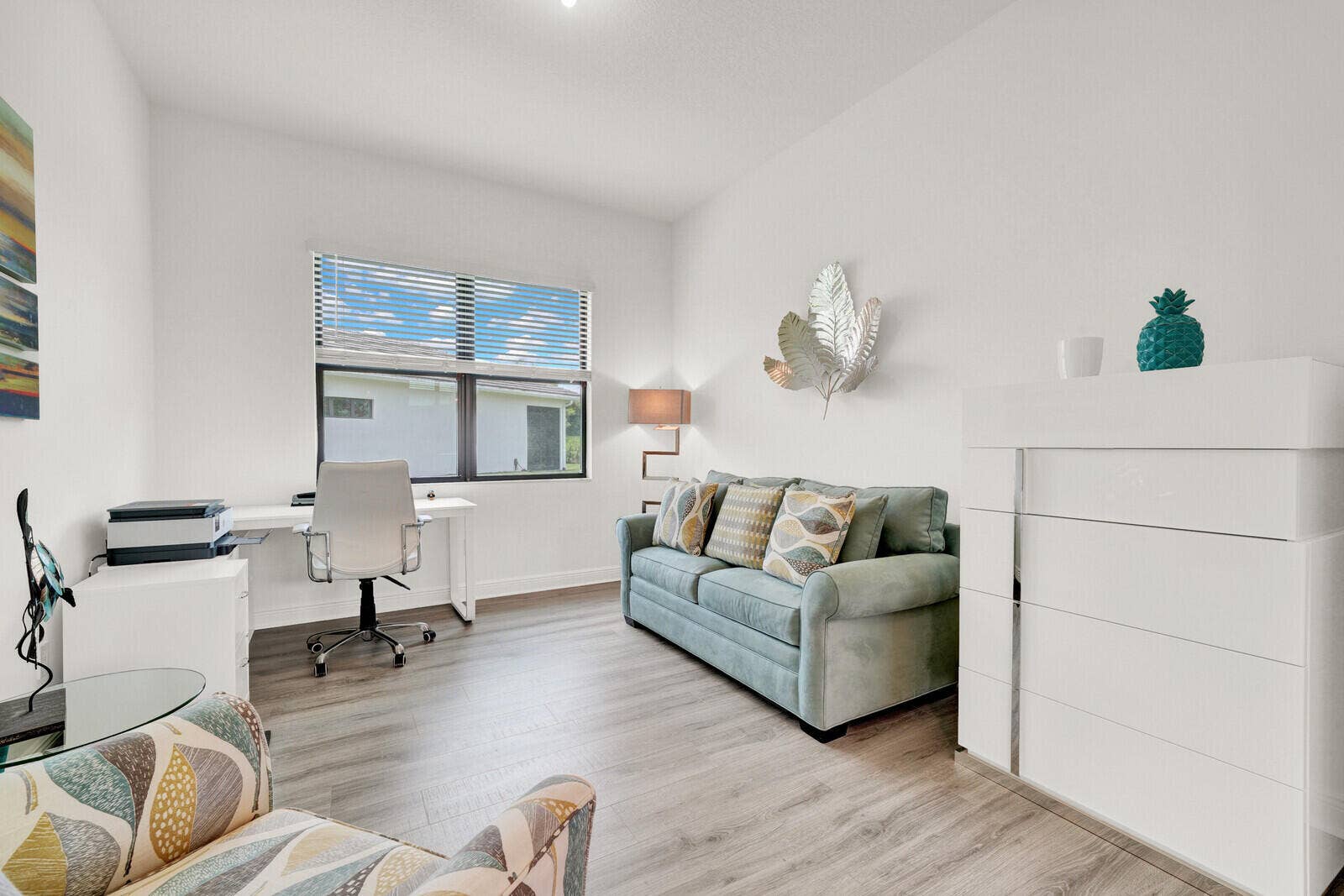 Interior space featuring wood-finish flooring, a large window with blinds, and recessed lighting