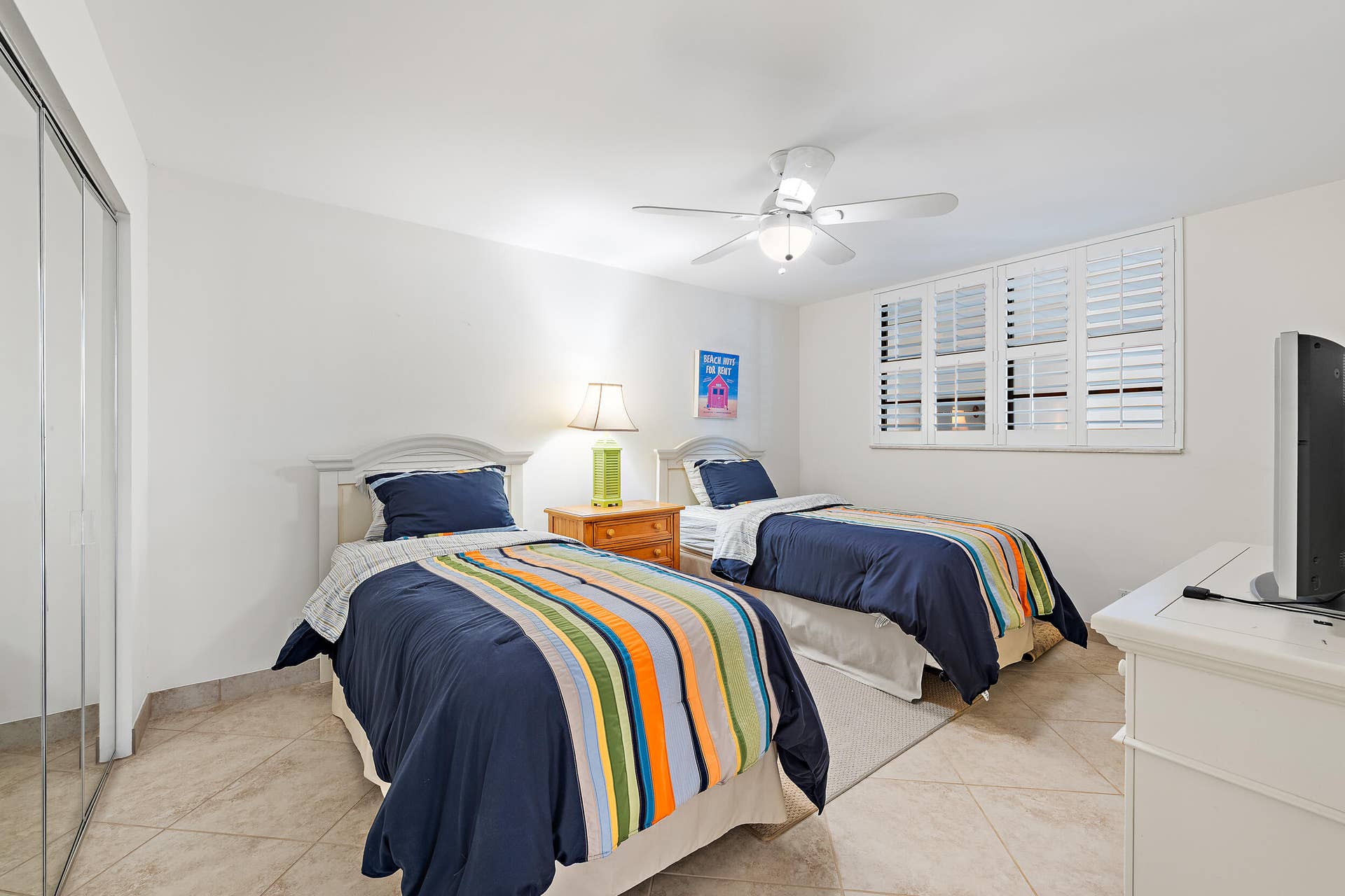900 Ocean Drive, #202, Juno Beach, FL 33408 2nd bedroom with plantation shutters, tile flooring and closet space