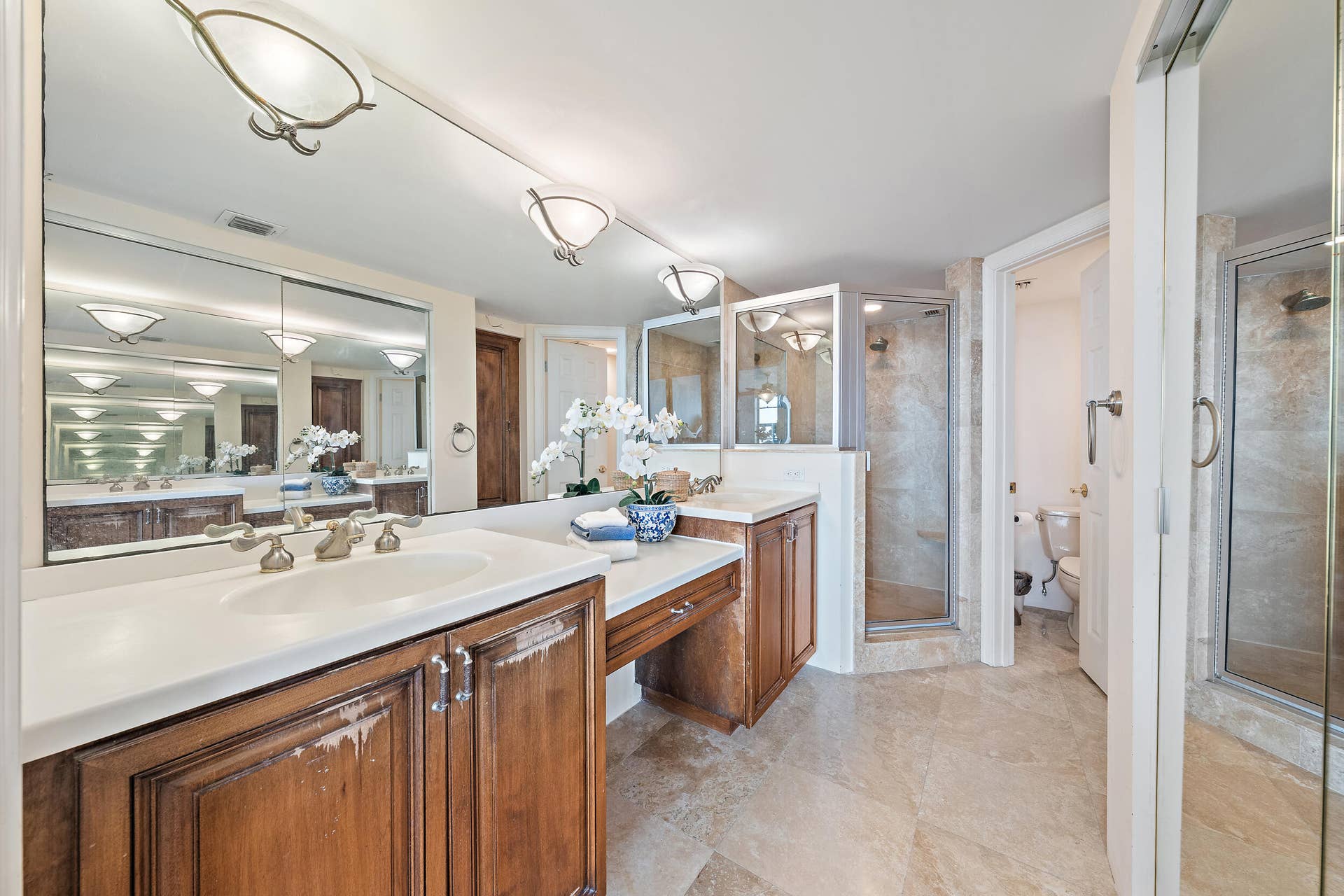 900 Ocean Drive, #202, Juno Beach, FL 33408 Primary bathroom with large walk-in closet, double sink and separate water closet