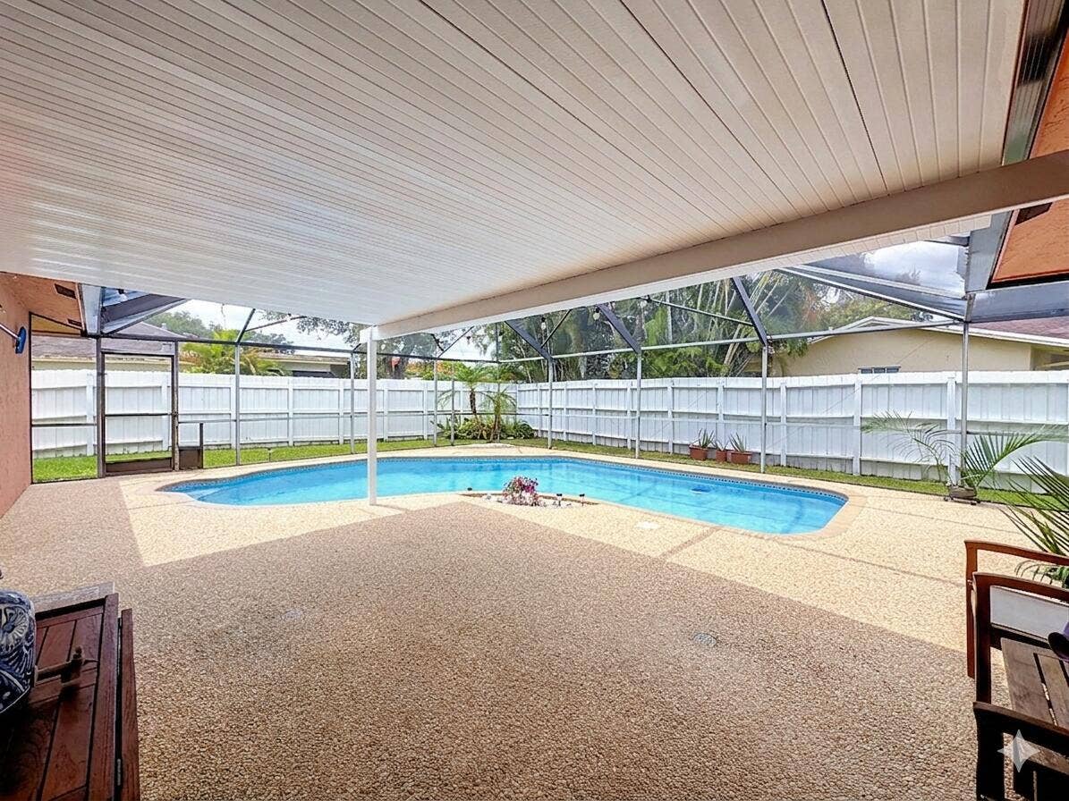 851 E Plantation Circle, Plantation, FL 33324 Covered pool area with done shaped screen