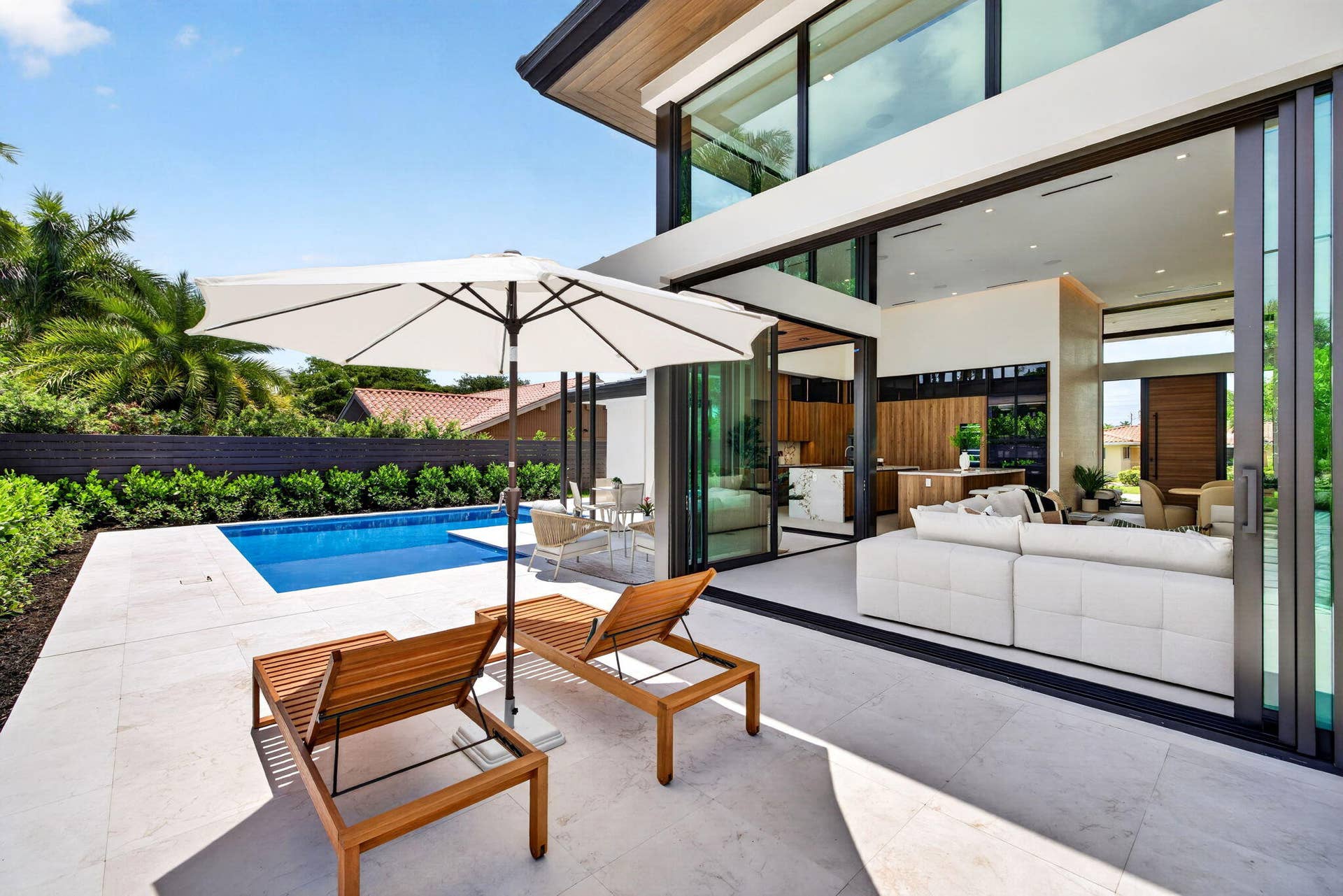 2717 NE 33rd Street, Fort Lauderdale, FL 33306 A resort-style patio setting connects the interiors to the pool, landscaping, and year-round open-air living.