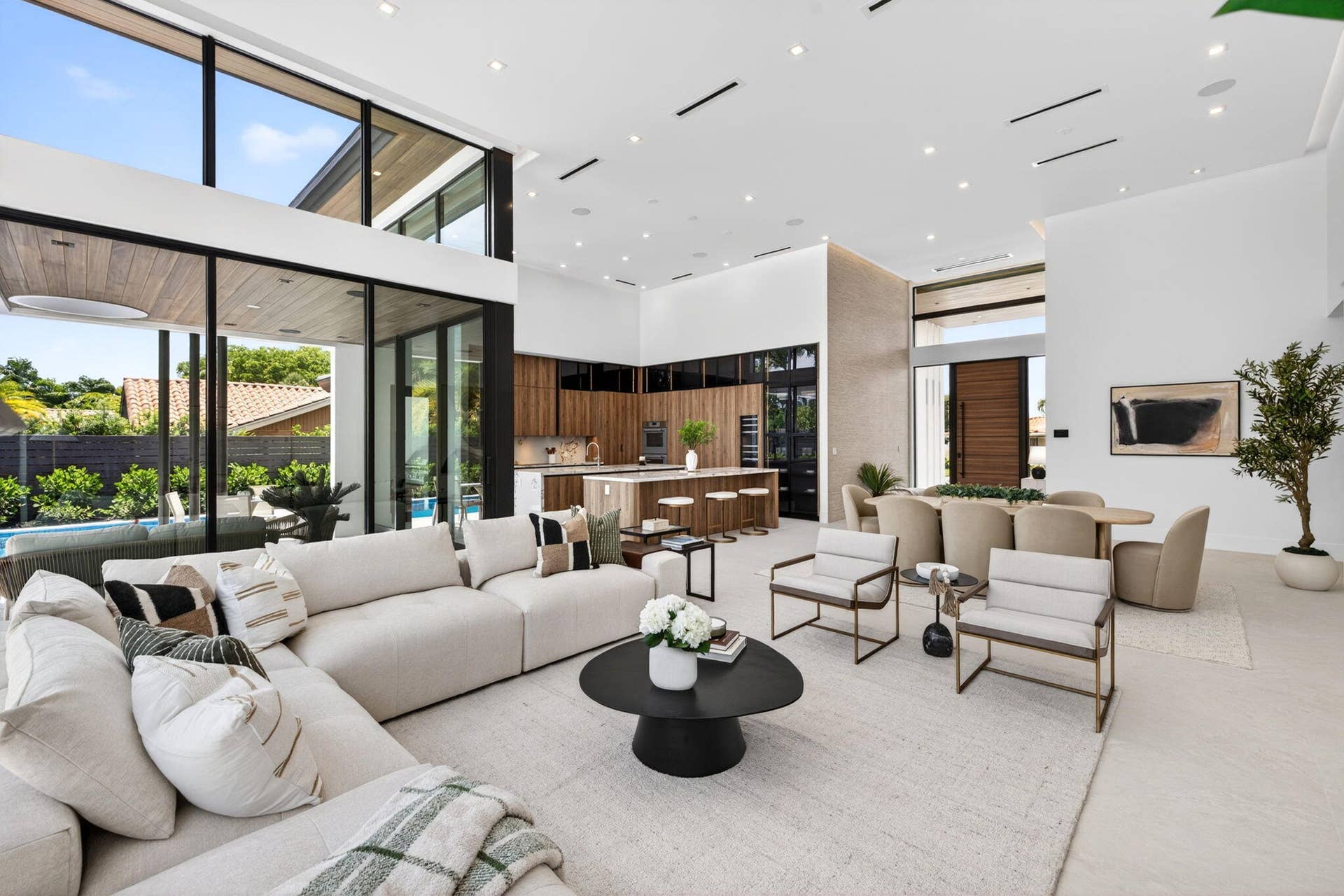 2717 NE 33rd Street, Fort Lauderdale, FL 33306 An open interior perspective captures the home's airy scale, refined material palette, and effortless single-story living.