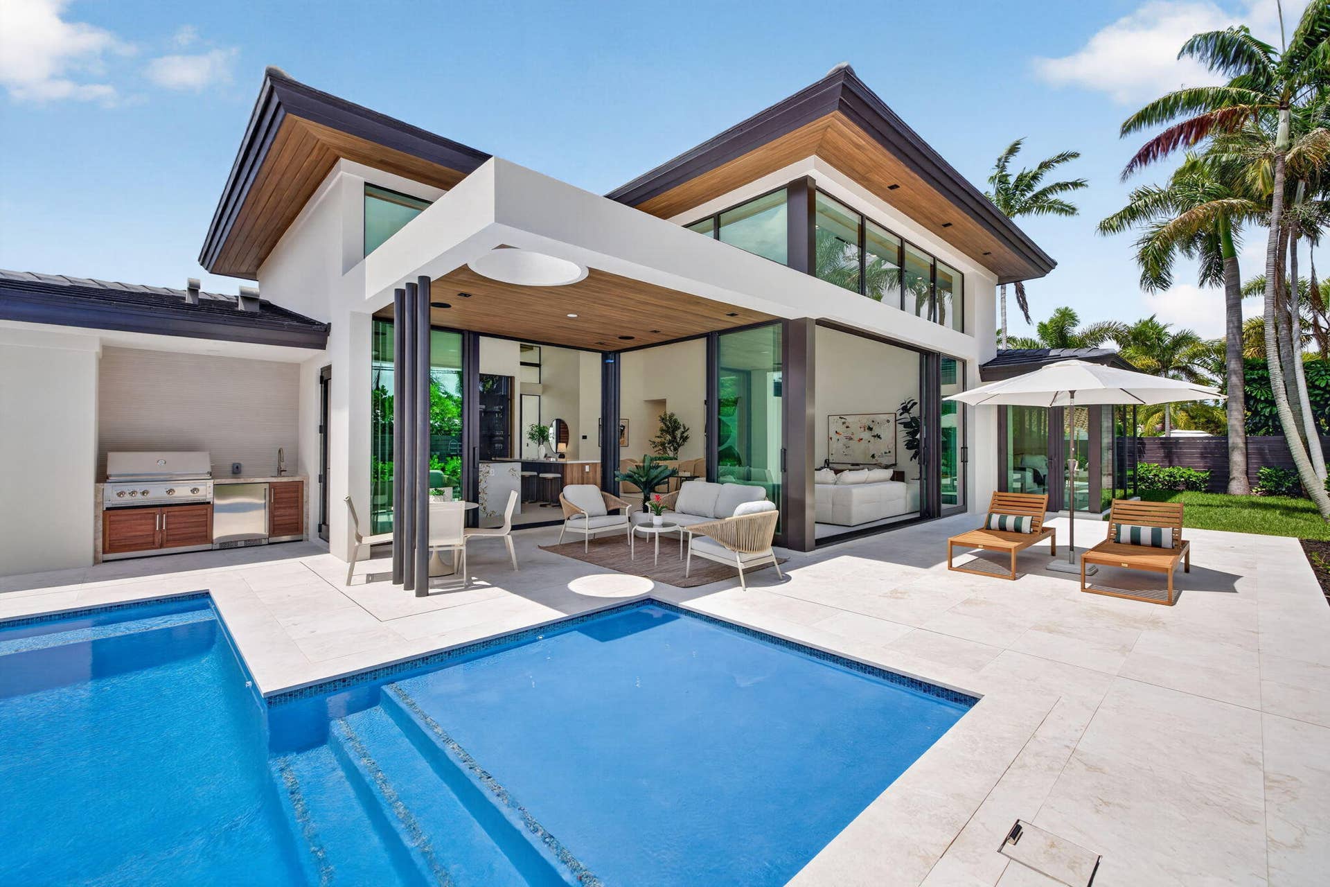 2717 NE 33rd Street, Fort Lauderdale, FL 33306 A resort-style patio setting connects the interiors to the pool, landscaping, and year-round open-air living.
