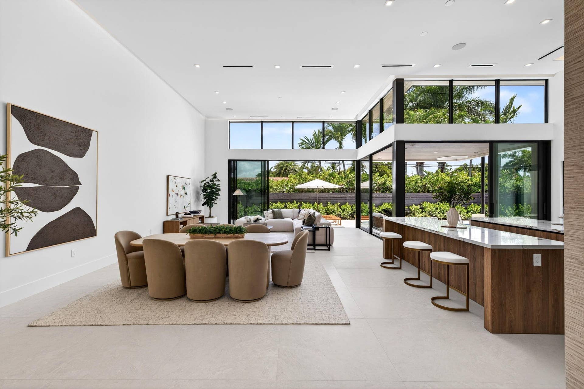 2717 NE 33rd Street, Fort Lauderdale, FL 33306 An open interior perspective captures the home's airy scale, refined material palette, and effortless single-story living.